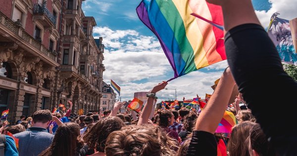 Protest signs and rainbow flags at a human rights demonstration in Europe