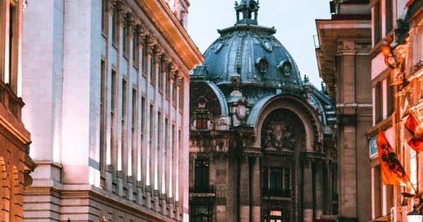 Bucharest's Old Town district at golden hour, showing historic architecture and pedestrian streets