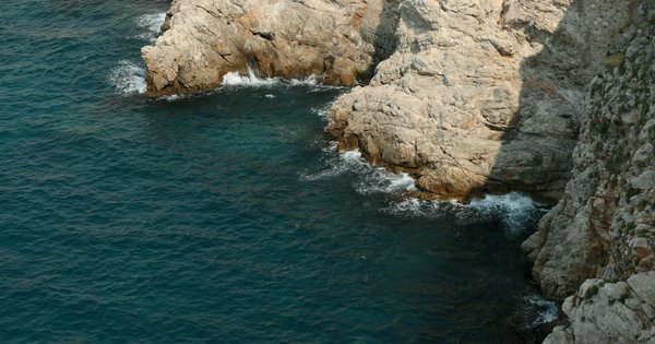 Turquoise Adriatic water along a rocky beach coastline in Croatia