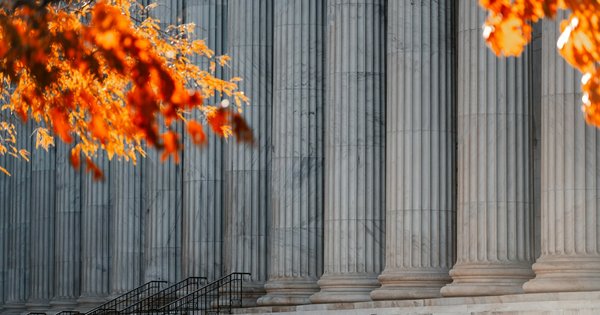 The exterior of a federal courthouse with pillars and concrete steps