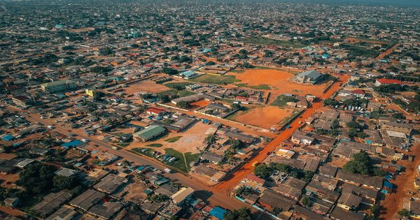Aerial view of Accra, Ghana, showing the city skyline and coastline under daylight