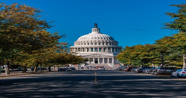 The United States Capitol dome against a clear sky