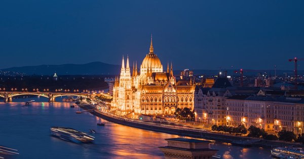 The Hungarian Parliament building illuminated at night above the Danube