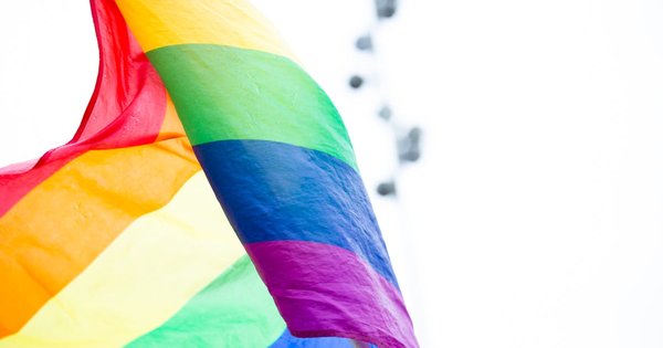 Rainbow flag waving in front of European Union institutional buildings