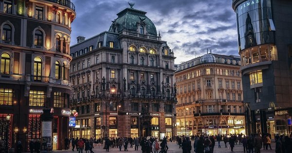 An aerial view of Vienna's rooftops and church spires at dusk