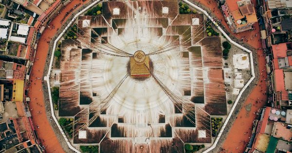 Aerial view of the Boudhanath Stupa, a Buddhist temple in Kathmandu, Nepal, ringed by prayer flags