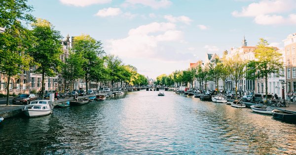 A row of historic Dutch canal houses beside a canal in the Netherlands
