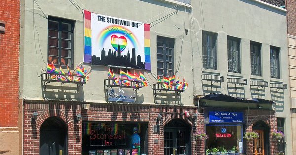 The Stonewall Inn in Greenwich Village, New York, with rainbow pride flags hanging above its entrance