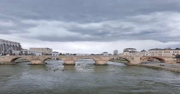 The Vardar river running through central Skopje with the Stone Bridge and surrounding buildings