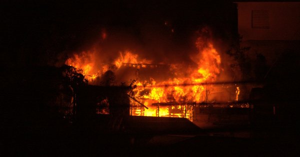 Emergency services and fire engines responding to a nightclub fire at night