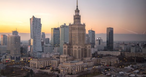 Warsaw skyline with Polish and EU flags visible