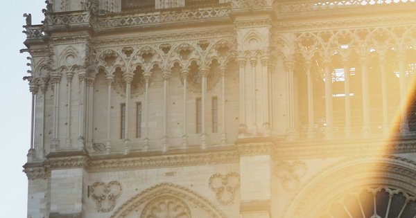 The sunlit facade and west tower of Notre-Dame de Paris cathedral