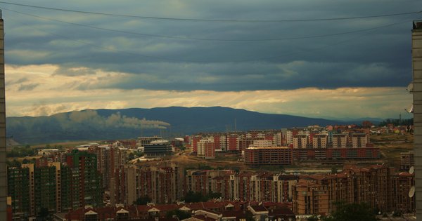 The skyline of Prishtina, Kosovo, with the city's National Library and surrounding buildings under an open sky