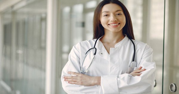 A medical professional in a clinical setting with a stethoscope