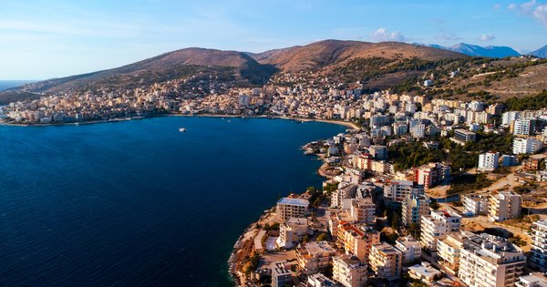 The Ionian coast and harbour of Sarandë, Albania, with mountains in the background