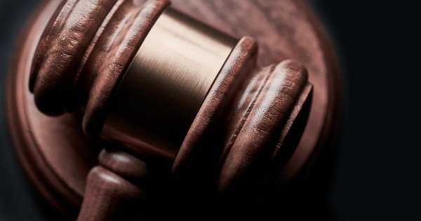 Close-up of a wooden judges gavel on a dark background