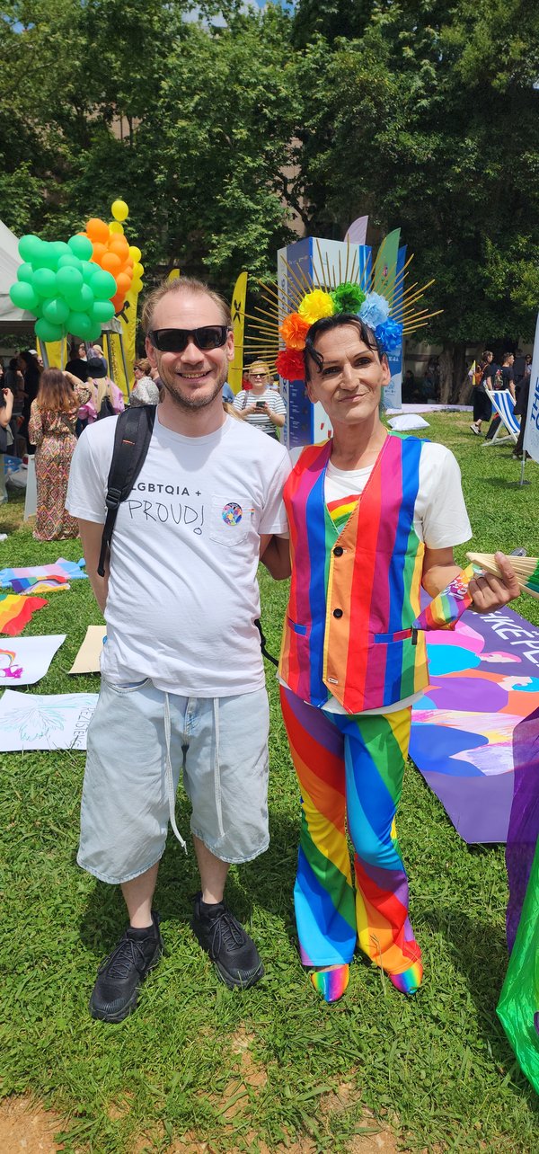 Jeff and Zachary at Tirana Pride 2026, rainbow outfit, smiling