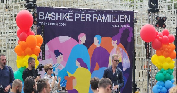 The Tirana Pride 2026 stage with a banner reading 'Bashkë për familjen' (Together for the Family), flanked by rainbow balloon columns