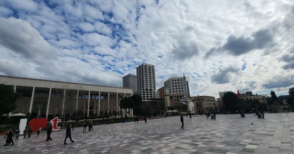 Skanderbeg Square in central Tirana, Albania, under a partly cloudy sky.