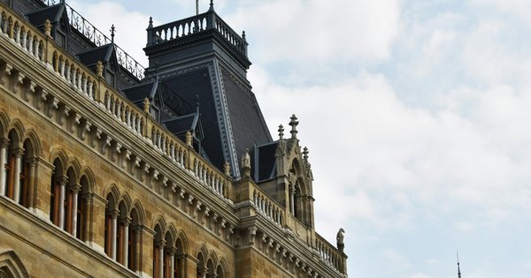 The neo-Gothic Vienna City Hall (Rathaus) at dusk, its spires lit against the sky
