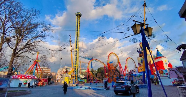 Crowd at Vienna's Prater park during Pride season with rainbow flags visible