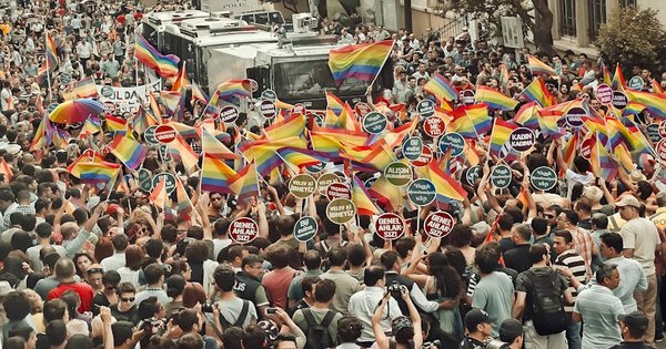 A large crowd marching with rainbow flags through central Zagreb, Croatia